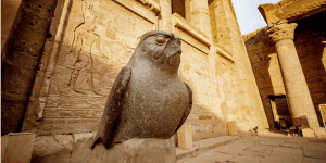 The granite statue of the falcon god Horus at the entrance of the Temple of Edfu, one of the best-preserved ancient temples in Egypt.