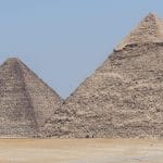 A panoramic view of the Great Pyramids of Giza under a clear blue sky, a key highlight of the private day tours from Hurghada offered by Top Class Egypt Travel.