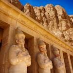 he Osirid statues and limestone colonnades of the Mortuary Temple of Hatshepsut at Deir el-Bahari, Luxor, during a private Top Class Egypt Travel excursion.