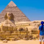 young man walking towards great sphinx giza 1 scaled 1 e1744475141574