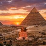 Sunset at the Giza Pyramids and Great Sphinx with orange sky