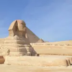 A side profile of the Great Sphinx of Giza with a pyramid in the background, visited during a private, expert-guided tour with Top Class Egypt Travel.