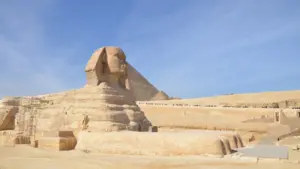 A side profile of the Great Sphinx of Giza with a pyramid in the background, visited during a private, expert-guided tour with Top Class Egypt Travel.