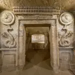 Detailed relief carvings and statue at the entrance of the Tomb of Mereruka in Saqqara