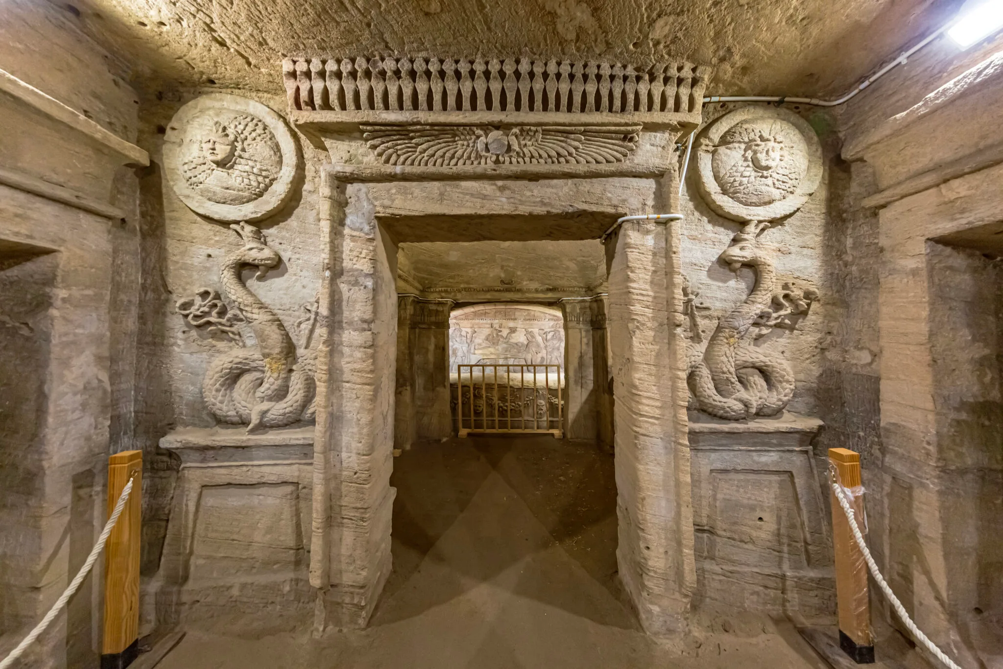 Detailed relief carvings and statue at the entrance of the Tomb of Mereruka in Saqqara