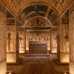 An interior view of a royal ancient Egyptian tomb in the Valley of the Queens, showcasing masterfully preserved colorful hieroglyphics and star-patterned ceilings.