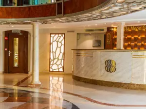 Marble reception desk with golden emblem and illuminated textured back wall inside a Nile cruise lobby
