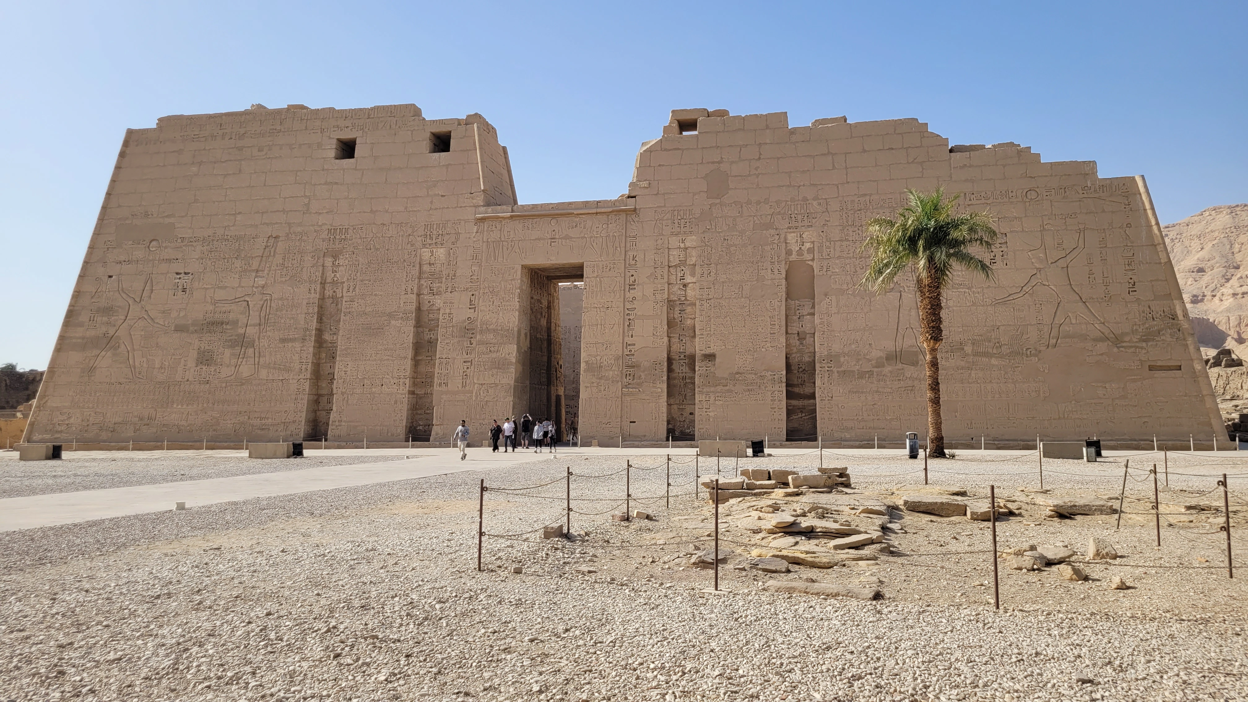 The monumental first pylon of Medinet Habu featuring colossal reliefs of Ramses III, a signature stop on a private West Bank tour with Top Class Egypt Travel.