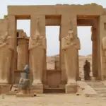 The majestic Osiride columns and colossal fallen statues at the Ramesseum, a highlight of the private West Bank archaeological tours by Top Class Egypt Travel.