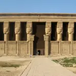 A symmetrical, detailed view of the monumental Temple of Hathor facade at Dendera, featuring famous Hathor-headed columns, optimized for exclusive tours by Top Class Egypt Travel.